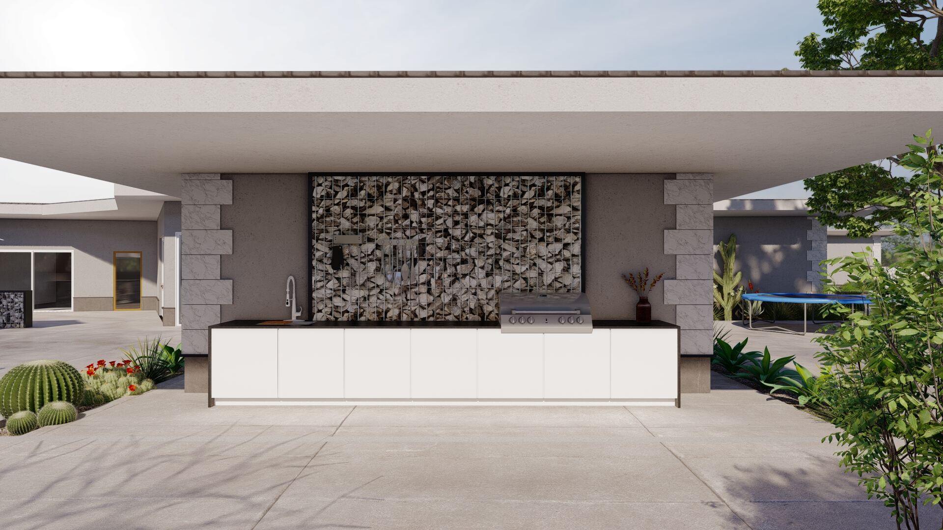 Outdoor kitchen with gabion feature wall and grill