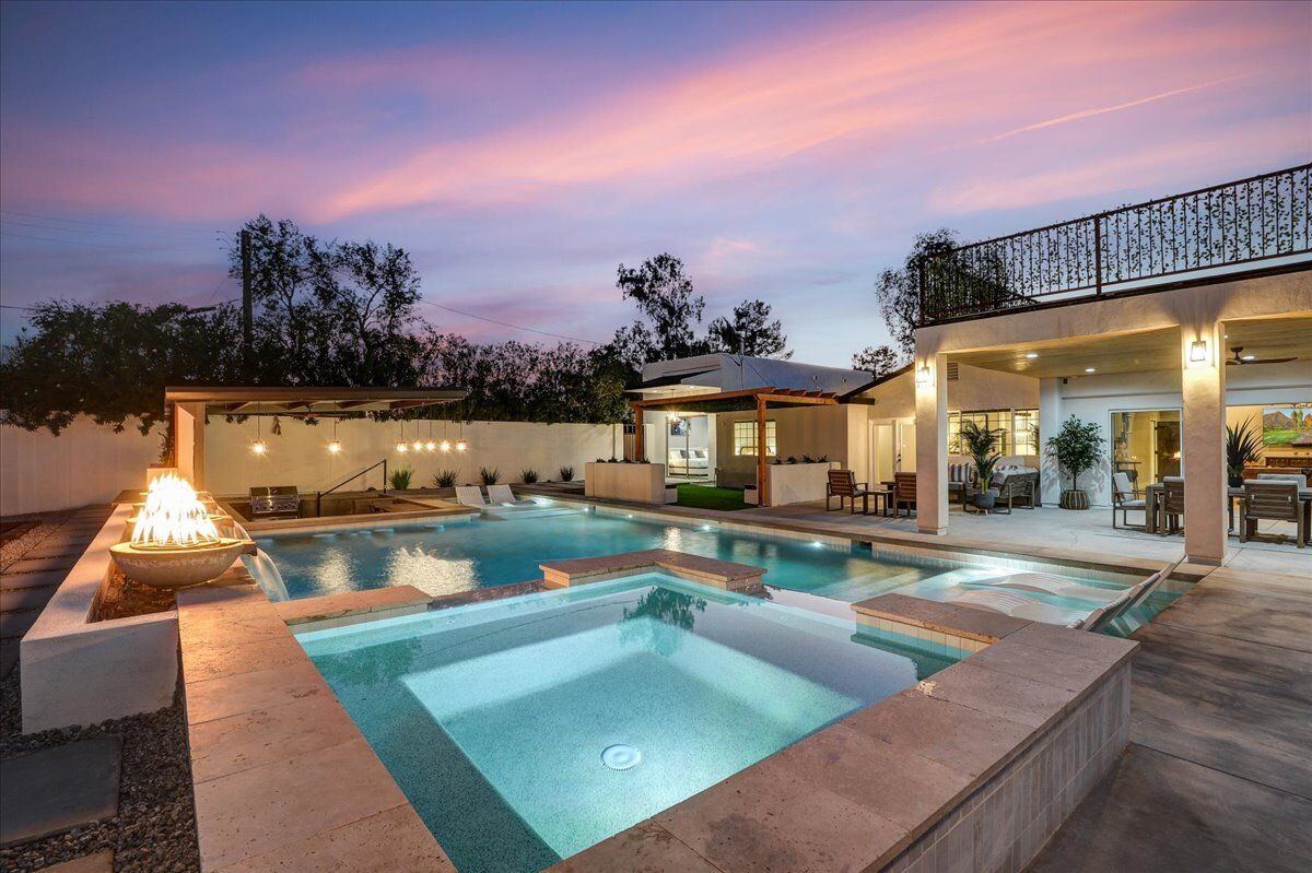 Twilight overview of pool, spa, and house