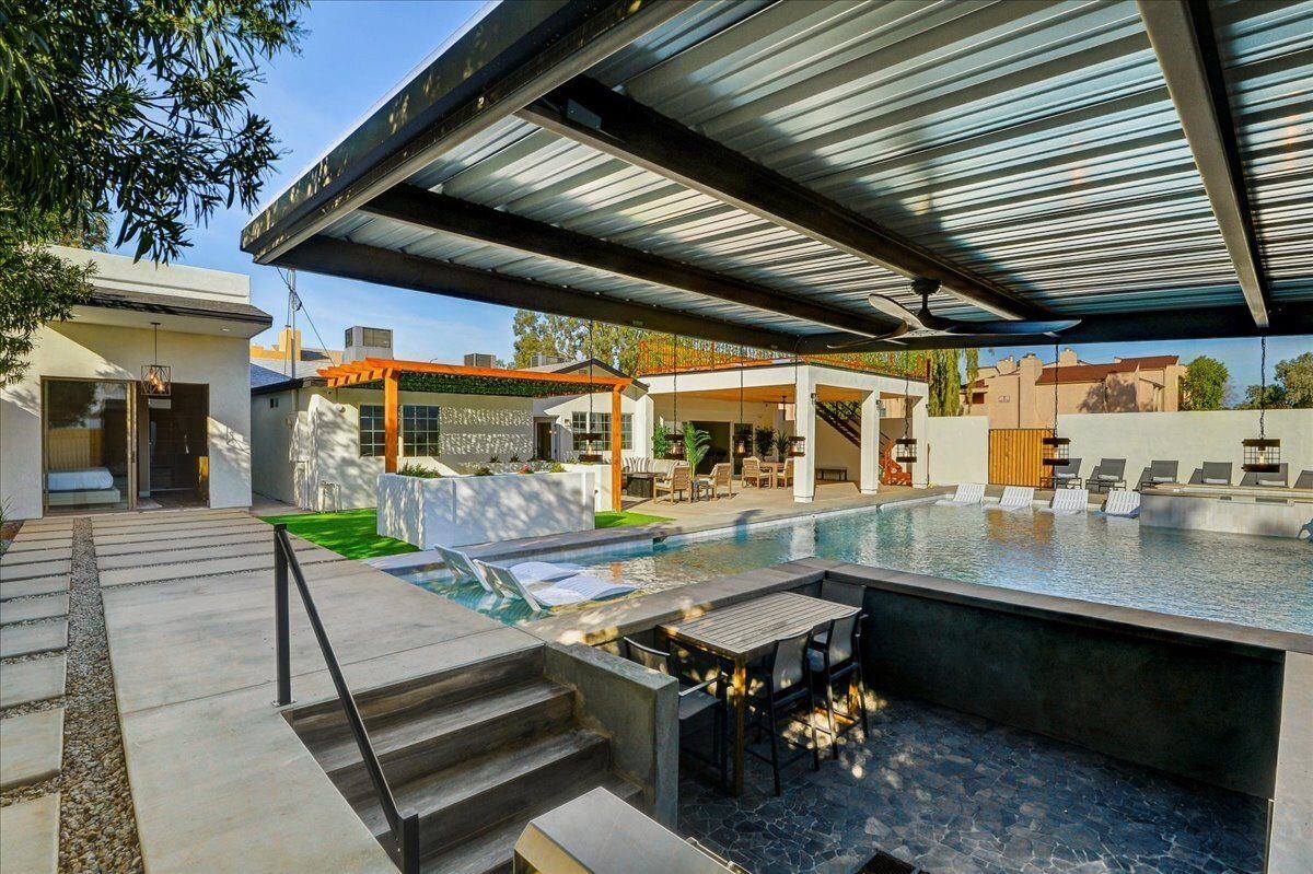 Daytime view from under the pergola toward the pool